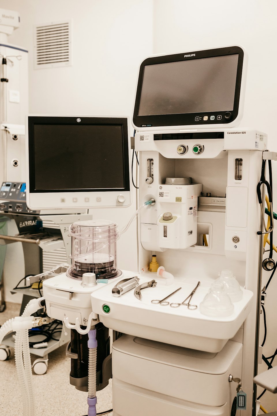 Anesthesia machine with monitors in a hospital operating room.
